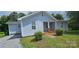 Charming single-story home with light blue siding, well-maintained landscaping, and a welcoming front porch at 2820 Bellhaven Cir, Charlotte, NC 28214