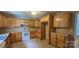 Spacious eat-in kitchen featuring wood cabinets, white appliances, and durable tile flooring at 2820 Bellhaven Cir, Charlotte, NC 28214