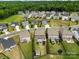 Aerial view of a residential neighborhood with well-maintained homes and green spaces and tree lines at 2835 Berkhamstead Cir, Concord, NC 28027