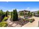 Manicured backyard featuring pergola, evergreens, walkway and lush lawn at 2835 Berkhamstead Cir, Concord, NC 28027