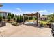 Beautiful backyard featuring a pergola with swing, tall hedges, and a well-manicured lawn at 2835 Berkhamstead Cir, Concord, NC 28027