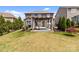 Large backyard featuring a pergola, lush lawn, privacy fence, and mature landscaping at 2835 Berkhamstead Cir, Concord, NC 28027