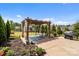 Relaxing pergola area surrounded by manicured landscaping and mature trees at 2835 Berkhamstead Cir, Concord, NC 28027