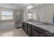 Elegant bathroom featuring double sinks with granite countertop, a soaking tub, and a glass shower at 2835 Berkhamstead Cir, Concord, NC 28027