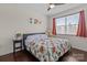 Bright bedroom features a comfortable bed with floral bedding, side table, and natural light at 2835 Berkhamstead Cir, Concord, NC 28027