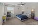 Comfortable carpeted bedroom features an upholstered bed, desk, and natural light for relaxation and study at 2835 Berkhamstead Cir, Concord, NC 28027