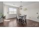 Cozy dining area featuring modern light fixture, neutral decor, and bright natural light from the window at 2835 Berkhamstead Cir, Concord, NC 28027
