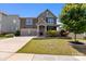 Stunning two-story house featuring a two-car garage, lush lawn, and stone veneer details at 2835 Berkhamstead Cir, Concord, NC 28027