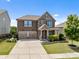 Beautiful two-story home featuring a two-car garage, manicured lawn and stone-accented facade at 2835 Berkhamstead Cir, Concord, NC 28027