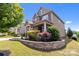 Beautiful two-story home featuring a well-kept yard, stone accents, and a welcoming covered porch at 2835 Berkhamstead Cir, Concord, NC 28027