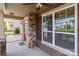 Cozy covered front porch featuring stone pillars, a ceiling fan, and a welcoming entrance at 2835 Berkhamstead Cir, Concord, NC 28027