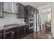 Stylish kitchen showcasing stainless steel appliances, granite countertops, gas range, and dark wood cabinets at 2835 Berkhamstead Cir, Concord, NC 28027