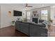 Cozy living room with a fireplace, large sectional couch, and hardwood floors for comfortable living at 2835 Berkhamstead Cir, Concord, NC 28027