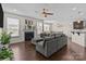 Open-concept living room with a fireplace, hardwood floors, and view of kitchen and dining area at 2835 Berkhamstead Cir, Concord, NC 28027