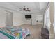 Open primary bedroom with tray ceiling, TV and large window, features an entrance to bonus room at 2835 Berkhamstead Cir, Concord, NC 28027