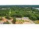 Aerial view of neighborhood with mature trees, a lake, and community amenities at 3078 Mountain Creek Dr, Sherrills Ford, NC 28673