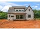 Back exterior of a modern farmhouse with a covered porch and large sliding glass doors at 3078 Mountain Creek Dr, Sherrills Ford, NC 28673