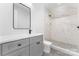 Modern bathroom featuring a gray vanity with a stone countertop and a tiled shower with a glass door at 3078 Mountain Creek Dr, Sherrills Ford, NC 28673