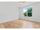 Modern bedroom with hardwood floors and a large window offering plenty of natural light at 3078 Mountain Creek Dr, Sherrills Ford, NC 28673