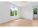 Bright bedroom featuring hardwood floors, a ceiling fan, and a large window at 3078 Mountain Creek Dr, Sherrills Ford, NC 28673