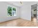 Bright bedroom featuring hardwood floors, a ceiling fan, and a window with views of the landscaped exterior at 3078 Mountain Creek Dr, Sherrills Ford, NC 28673