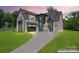 A modern two-story home featuring a gray roof, mixed siding, and a concrete driveway at 3078 Mountain Creek Dr, Sherrills Ford, NC 28673