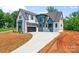 A modern two-story home featuring a gray roof, mixed siding, and a concrete driveway at 3078 Mountain Creek Dr, Sherrills Ford, NC 28673