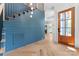 A blue foyer area featuring an open staircase and herringbone hardwood flooring at 3078 Mountain Creek Dr, Sherrills Ford, NC 28673