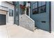 Modern home's front entrance featuring stone accents, blue siding, and stained wood door frame at 3078 Mountain Creek Dr, Sherrills Ford, NC 28673