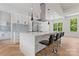 A modern kitchen features a waterfall island, stainless steel appliances, and herringbone wood floors at 3078 Mountain Creek Dr, Sherrills Ford, NC 28673