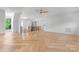 Open-concept living room with hardwood floors, natural light, and a view of the staircase at 3078 Mountain Creek Dr, Sherrills Ford, NC 28673
