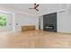 Large living area with wood floors, black fireplace, and built-in cabinets at 3078 Mountain Creek Dr, Sherrills Ford, NC 28673