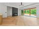 Spacious living room featuring hardwood floors, black stone fireplace, ceiling fan, and sliding glass doors at 3078 Mountain Creek Dr, Sherrills Ford, NC 28673