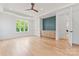Spacious main bedroom with hardwood floors, a ceiling fan, and custom built-in shelves and cabinets at 3078 Mountain Creek Dr, Sherrills Ford, NC 28673