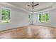 Bright main bedroom with hardwood floors, tray ceiling, and ample natural light from multiple windows at 3078 Mountain Creek Dr, Sherrills Ford, NC 28673