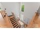 Modern staircase with wooden handrails and a decorative chandelier at 3078 Mountain Creek Dr, Sherrills Ford, NC 28673
