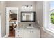 Modern bathroom with granite counters, vanity and stylish mirror, with view to bedroom at 314 Center Dr, Davidson, NC 28036