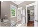 Bright bathroom featuring double doors to closet, granite countertops and a large window at 314 Center Dr, Davidson, NC 28036