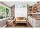 Bright bonus room with large windows, a couch, and built-in cabinets with a sink at 314 Center Dr, Davidson, NC 28036