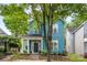 Charming two-story blue home with a welcoming front porch and beautifully landscaped front yard at 314 Center Dr, Davidson, NC 28036