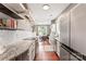 Bright, galley kitchen with stainless steel appliances flowing into the dining area at 314 Center Dr, Davidson, NC 28036