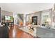 Bright living room with hardwood floors, stylish furniture, and a staircase in the background at 314 Center Dr, Davidson, NC 28036