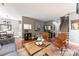 Open living space with hardwood floors, stylish seating, and a view into the dining area and staircase at 314 Center Dr, Davidson, NC 28036