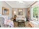 Cozy living room featuring neutral tones, a plush sofa, and a large window for natural light at 314 Center Dr, Davidson, NC 28036