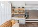 Living room area with built-in shelving and cabinets, butcher block counters, decor, and a neutral color palette at 314 Center Dr, Davidson, NC 28036