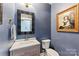Stylish powder room with blue walls, modern vanity, and elegant gold accents at 314 Center Dr, Davidson, NC 28036