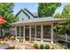 Cozy sun room with neutral decor, screened windows, and a manicured garden outside at 314 Center Dr, Davidson, NC 28036