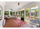 Relaxing sunroom featuring large windows, an overhead fan, and rocking chairs at 314 Center Dr, Davidson, NC 28036
