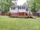 Charming home featuring a spacious backyard with a wooden deck, ideal for outdoor entertaining and relaxation at 318 Chestnut Ave, Kannapolis, NC 28081