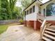 Home's exterior showcases a wooden deck, brick foundation, and fenced backyard at 318 Chestnut Ave, Kannapolis, NC 28081